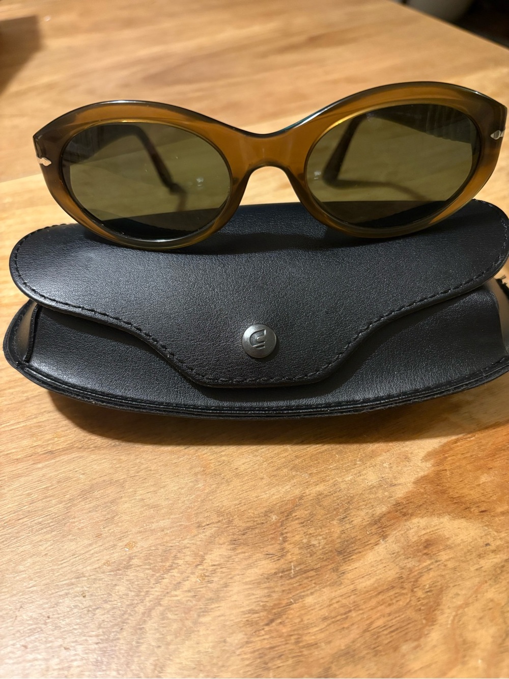 Brown Persol Sunglasses with olive lenses.
